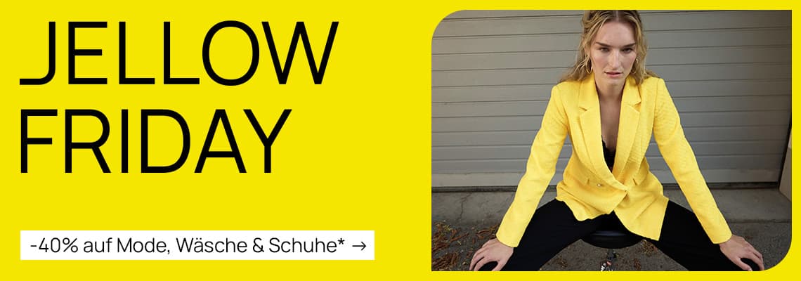 -40 % auf Mode, Wäsche & Schuhe – Frau in gelbem Blazer und schwarzer Hose sitzt auf einem Hocker