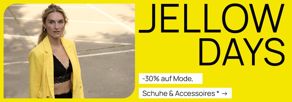 -30 % auf Mode, Schuhe & Accessoires – Person in gelbem Blazer und schwarzem Top steht im Freien